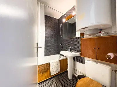 a small bathroom with a sink and a mirror at Appartement Proche Des Pistes By TerraAlpina in Saint-Gervais-les-Bains