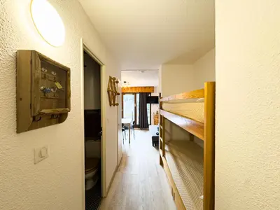 a hallway with bunk beds in a room at Appartement Proche Des Pistes By TerraAlpina in Saint-Gervais-les-Bains