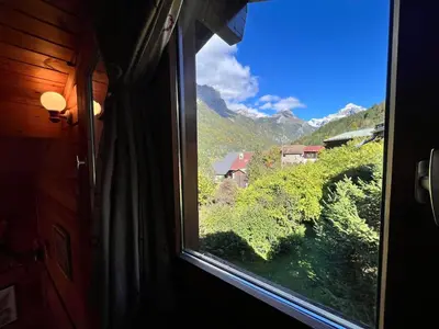 a window view of a mountain view from a train at Chalet paisible avec cheminée et animaux acceptés près des pistes - FR-1-624-176 in Sixt
