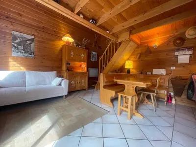 a living room with a white couch and a table at Chalet paisible avec cheminée et animaux acceptés près des pistes - FR-1-624-176 in Sixt