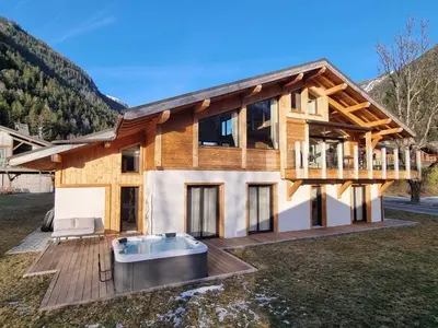 a log home with a hot tub on a deck at Chalet avec jacuzzi et animaux admis, vue Mont-Blanc - FR-1-343-259 in Chamonix-Mont-Blanc