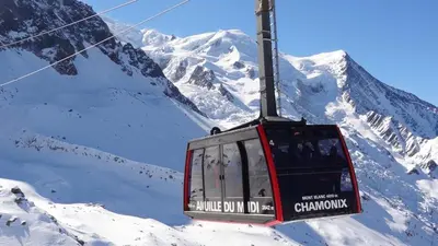 a ski lift in front of a snow covered mountain at Au Coin du Mont Blanc in Chamonix-Mont-Blanc