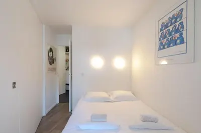 a white room with a bed with two pillows at Au Coin du Mont Blanc in Chamonix-Mont-Blanc