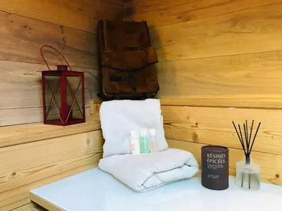 a room with a wooden wall with towels and a lantern at Cosy duplex with Hammam-Steamroom in Rochebrune in Megève