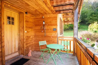 a table and chairs on a porch of a cabin at Petit Brio - Fabulous apartment in Samoens sleeps up to 4 in Samoëns
