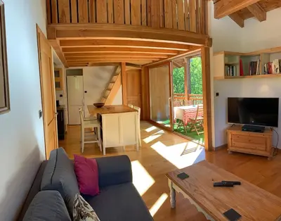 a living room with a couch and a table at Petit Brio - Fabulous apartment in Samoens sleeps up to 4 in Samoëns