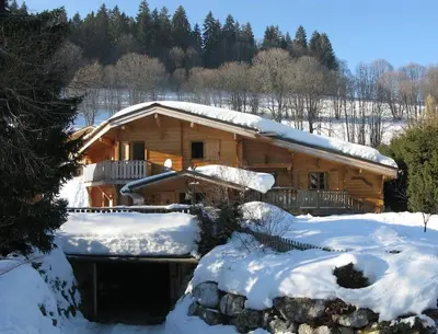 a log cabin in the snow with snow at Chalet vue montagne , proche des pistes in Megève