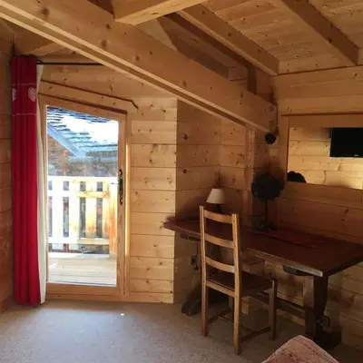 a wooden room with a wooden desk and a window at Chalet vue montagne , proche des pistes in Megève