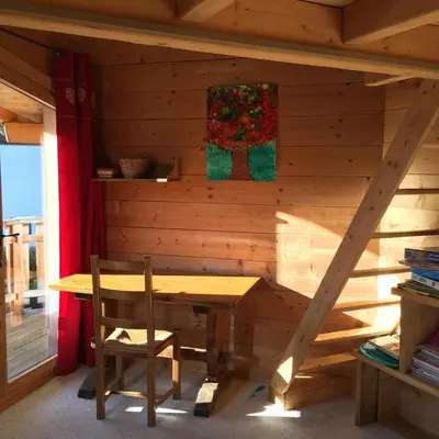 a wooden room with a wooden table and a chair at Chalet vue montagne , proche des pistes in Megève