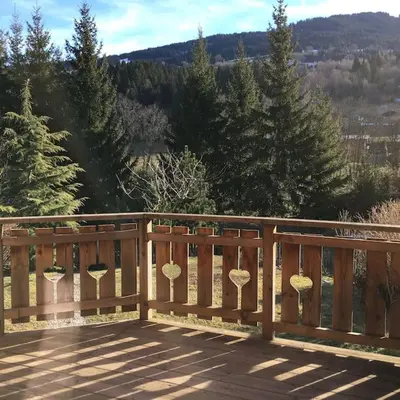 a wooden deck with some mushrooms on it at Chalet vue montagne , proche des pistes in Megève