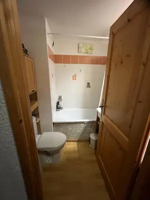 a bathroom with a toilet and a bath tub at Studio Résidence grand tetras in Samoëns