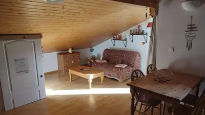 a living room with a couch and a table at Studio Résidence grand tetras in Samoëns