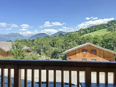 a view of the mountains from the deck of a cabin at Appartement standing à Combloux avec balcon et parking - FR-1-560-156 in Combloux