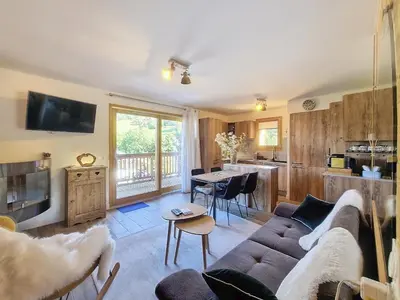 a living room with a couch and a table at Appartement standing à Combloux avec balcon et parking - FR-1-560-156 in Combloux