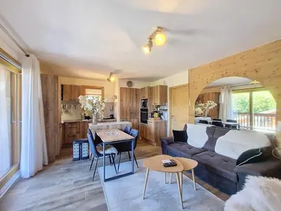 a living room with a couch and a table at Appartement standing à Combloux avec balcon et parking - FR-1-560-156 in Combloux