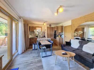 a living room with a couch and a table at Appartement standing à Combloux avec balcon et parking - FR-1-560-156 in Combloux