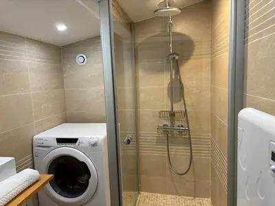 a shower with a washing machine in a bathroom at Le Flocon - Centre - Megève - Wifi - Duplex in Megève