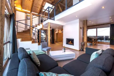 a living room with a couch and a fireplace at Chalet Les Rots Home in Samoëns