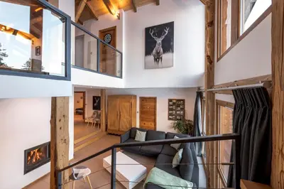 a living room with a couch and a fireplace at Chalet Les Rots Home in Samoëns