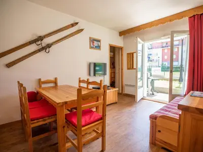 a living room with a table and chairs and a dining room at Parfait pour 6 personnes au pied des télécabines in Saint-Gervais-les-Bains