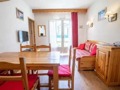 a living room with a table and a couch at Parfait pour 6 personnes au pied des télécabines in Saint-Gervais-les-Bains
