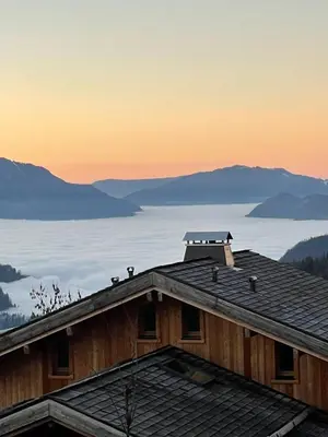 a roof of a house with a view of the mountains at Appartement de charme familial aux CARROZ d ARACHES in Arâches-la-Frasse