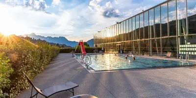 a building with a swimming pool in front of it at La Cabane Charmant T2 avec jardin centre village in Saint-Gervais-les-Bains