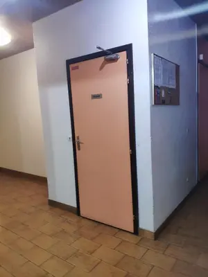 an elevator door in a room with a wall at La Cabane Charmant T2 avec jardin centre village in Saint-Gervais-les-Bains