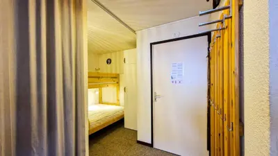 a door to a room with a bed and bunk beds at Résidence Verseau - Appartement lumineux et spacieux · Centre station · avec cabine et Balcon MAE-7781 in Magland
