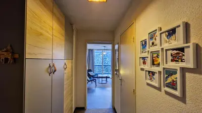 a hallway with pictures on the walls of a room at Résidence Verseau - Appartement lumineux et spacieux · Centre station · avec cabine et Balcon MAE-7781 in Magland
