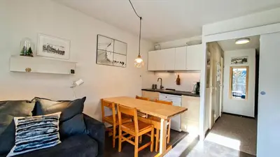 a living room with a couch and a wooden table at Résidence Verseau - Appartement lumineux et spacieux · Centre station · avec cabine et Balcon MAE-7781 in Magland