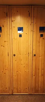 a wooden wall with stickers on it at Cozy comfort, pool and spa close to Mont Blanc in Vallorcine
