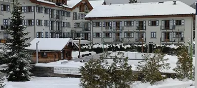 a group of buildings with snow on the ground at Cozy comfort, pool and spa close to Mont Blanc in Vallorcine