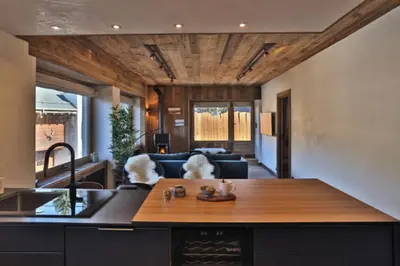a kitchen and living room with a sink and a counter at Stunning luxury apartment in Megève