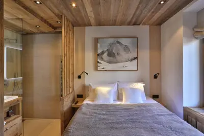 a bedroom with a large bed and a shower at Stunning luxury apartment in Megève