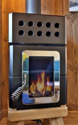 a oven with a fire inside of it at Stunning luxury apartment in Megève