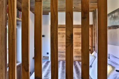 a view through the wooden fence of a room at Stunning luxury apartment in Megève