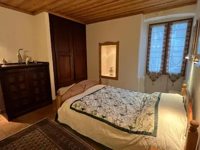 a bedroom with a bed and a dresser and a window at Appartement au cœur de Samoëns – 3 chambres, 2 sdb, parking inclus - FR-1-629-143 in Samoëns