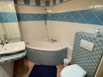 a bathroom with a toilet and a tub and a sink at Appartement au cœur de Samoëns – 3 chambres, 2 sdb, parking inclus - FR-1-629-143 in Samoëns