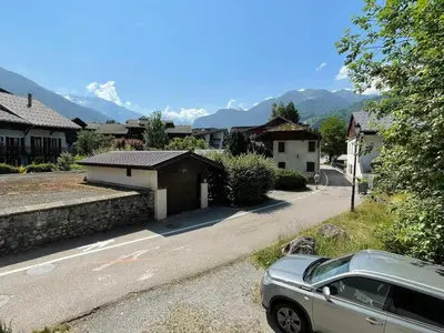 a car parked in front of a street with houses at Appartement au cœur de Samoëns – 3 chambres, 2 sdb, parking inclus - FR-1-629-143 in Samoëns