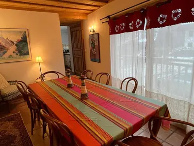 a dining room with a table with chairs and a window at Appartement au cœur de Samoëns – 3 chambres, 2 sdb, parking inclus - FR-1-629-143 in Samoëns