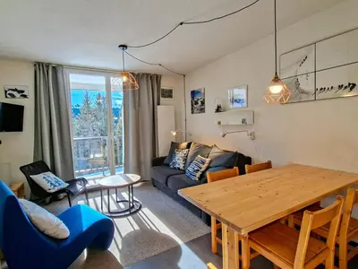 a living room with a table and a couch at Appartement spacieux 6 pers, balcon, Flaine centre - FR-1-425-229 in Arâches-la-Frasse