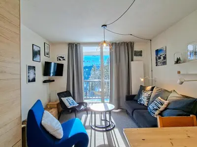 a living room with a couch and a table at Appartement spacieux 6 pers, balcon, Flaine centre - FR-1-425-229 in Arâches-la-Frasse