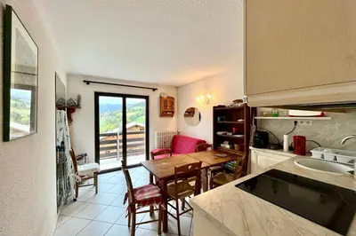 a kitchen with a table and a dining room at 2-room apartment with balcony close to the slopes in Combloux