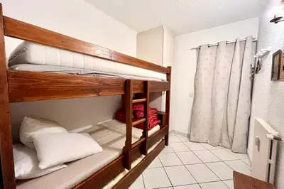 a room with two bunk beds in a room at 2-room apartment with balcony close to the slopes in Combloux