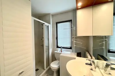 a bathroom with a toilet and a sink at 2-room apartment with balcony close to the slopes in Combloux