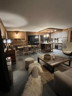 a living room with a sheep laying on the floor at Confort et Proximité in Megève