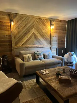 a living room with a couch and a coffee table at Confort et Proximité in Megève