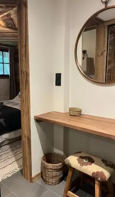 a room with a table and a mirror and a stool at Confort et Proximité in Megève