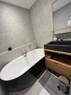 a bathroom with a white tub and a sink at Confort et Proximité in Megève